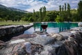 Drink in tall glass in poolside. Refreshment on summer day. Purple juice cocktail or vine. Royalty Free Stock Photo