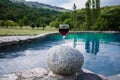 Drink in tall glass in poolside. Refreshment on summer day. Purple juice cocktail or vine. Royalty Free Stock Photo