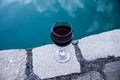 Drink in tall glass in poolside. Refreshment on summer day. Purple juice cocktail or vine. Royalty Free Stock Photo