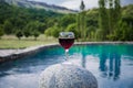 Drink in tall glass in poolside. Refreshment on summer day. Purple juice cocktail or vine. Royalty Free Stock Photo