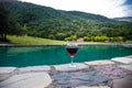 Drink in tall glass in poolside. Refreshment on summer day. Purple juice cocktail or vine. Royalty Free Stock Photo