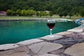 Drink in tall glass in poolside. Refreshment on summer day. Purple juice cocktail or vine. Royalty Free Stock Photo