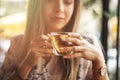 Drink Tea relax cosy photo with blurred background. Female hands holding mug of hot Tea in morning. Young woman relaxing tea cup Royalty Free Stock Photo