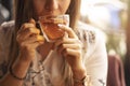 Drink Tea relax cosy photo with blurred background. Female hands holding mug of hot Tea in morning. Young woman relaxing tea cup Royalty Free Stock Photo