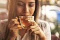 Drink Tea relax cosy photo with blurred background. Female hands holding mug of hot Tea in morning. Young woman relaxing tea cup Royalty Free Stock Photo