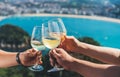 Drink two glasses white wine in friends hands outdoor seascape holiday Royalty Free Stock Photo