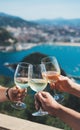 Drink two glasses white wine in friends hands outdoor seascape holidays, romantic couple toast with alcohol, enjoying travel time Royalty Free Stock Photo