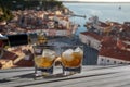 Drink for two on a terrace overlooking a small town on the Croatian coast. Two glasses of liquo