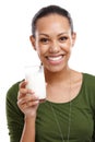 Drink up the nutrition. Portrait of an attractive young woman holding a glass of milk isolated on white. Royalty Free Stock Photo