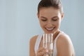 Drink water. Smiling woman holding fresh pure water in glass