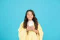 Drink well, live well. little girl drink cocoa or milk before sleeping. cosy and fluffy pajama. feeling comfortable at