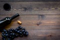 Drink wine concept. Bottle, glass, grape on wooden background top view copyspace