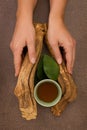 Drinking ayahuasca. Brew and bowl in woman hands Royalty Free Stock Photo