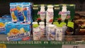 Drinking baby yogurt on the shelves of a supermarket