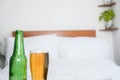 Drinking beer, alcohol before seeping with a glass of beer and an empty bottle in bed, alcoholic concept Royalty Free Stock Photo