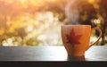 Drinking Coffee in Autumn. Relaxing in Fall Season by Hot Coffee Outdoors Concept. Side View. Golden bokeh from Foliages Royalty Free Stock Photo