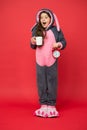 Drinking coffee energy. Morning routines. Adorable bunny hold alarm clock. Small girl in bunny costume. Child rabbit Royalty Free Stock Photo