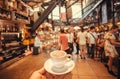 Drinking coffee inside huge space of modern market with bars, tables and fast food stores, Florence, Italy