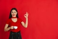 Caucasian young woman`s monochrome portrait on red studio background, emotional and expressive Royalty Free Stock Photo