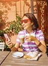 Drinking coffee and using phone in italian cafe, lifestyle, food and technology concept