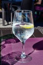 Drinking cold mineral water with bubbles, served in wine glass with ice cubes and lemon Royalty Free Stock Photo