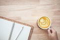 Drinking concepts with female hand holding coffee cup on wood table Royalty Free Stock Photo