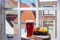 Drinking dark beer with fried cod fish fillet and french fried potatoed chips with view on street in old Zierikzee town, Zeeland,