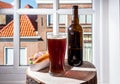 Drinking dark beer with smoked eel fish sandwich with view on street in old Zierikzee town, Zeeland, Netherland