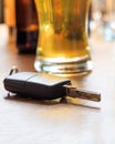 Drinking and driving. Car key on a pub counter, closeup view Royalty Free Stock Photo