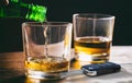 Drinking and driving concept. Car key and alcohol glass on wooden background. 3d illustration Royalty Free Stock Photo