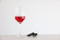 Drinking and driving concept shot. Tall wine glass with RosÃÂ© wine next to nondescript car key. Studio shot, no people