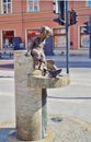 Drinking fountain decorated by sculptures of kids and a catfish on central Piotrkowska Street