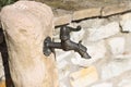 Drinking fountain detail with an iron dragon head faucet Royalty Free Stock Photo