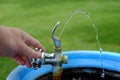 Drinking Fountain with Water Flowing to Drink Hand Turning Valve Wet Royalty Free Stock Photo