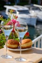 Drinking of French brut champagne sparkling wine in glasses, club party in yacht harbour of Port Grimaud near Saint-Tropez, French Royalty Free Stock Photo