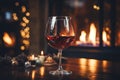 Drinking a glass of red wine in front of fireplace. Relaxing by the fire in cozy living room on winter day. Celebrating Christmas Royalty Free Stock Photo