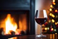 Drinking a glass of red wine in front of fireplace. Relaxing by the fire in cozy living room on winter day. Celebrating Christmas Royalty Free Stock Photo