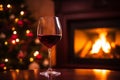 Drinking a glass of red wine in front of fireplace. Relaxing by the fire in cozy living room on winter day. Celebrating Christmas Royalty Free Stock Photo