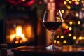 Drinking a glass of red wine in front of fireplace. Relaxing by the fire in cozy living room on winter day. Celebrating Christmas Royalty Free Stock Photo