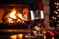 Drinking a glass of red wine in front of fireplace. Relaxing by the fire in cozy living room on winter day. Celebrating Christmas Royalty Free Stock Photo