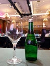 drinking glasses and green bottles on a gray table in the meeting room