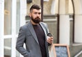 Drinking his cup first thing in the morning. Businessman in hipster style holding takeaway coffee. Hipster with Royalty Free Stock Photo