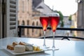 Drinking of Kir Royal, French aperitif cocktail made from creme de cassis topped with champagne, typically served in flute glass