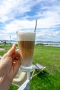 drinking latte macchiato caffee at lake Balaton in Hungary on the beach