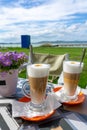 drinking latte macchiato caffee together at lake Balaton in Hungary on the beach