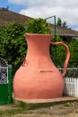 Drinking pitcher-shaped well in front of the house. Symbol of hospitality. The traditional culture of wine villages Royalty Free Stock Photo