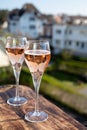 Drinking of rose champagne sparkling wine from flute glasses on outdoor terrace in France Royalty Free Stock Photo