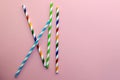 Drinking Straw. Drinking paper colorful straws for summer cocktails on a pink background with copy space. Royalty Free Stock Photo