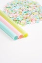 Drinking straws and microplastics on a white background. Impact of micro plastic on the food chain. The idea of micro plastic