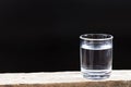 Drinking water on a dark background. Royalty Free Stock Photo